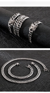 Detailed macro view of silver Cuban link chains with intricate dragon head clasps
