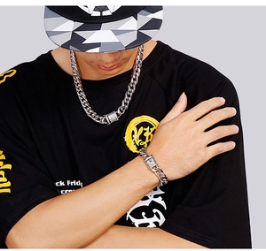 Close-up of iced out Cuban link chain with zircon-studded clasp on a male model
