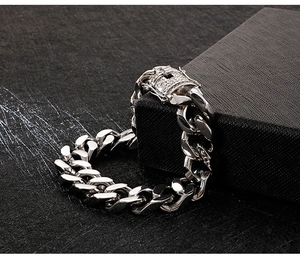 Detailed close-up of a silver Cuban link chain featuring a luxury diamond-encrusted clasp