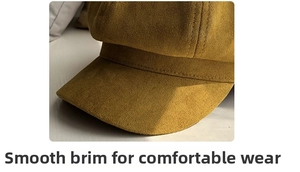 Detailed macro view of mustard yellow suede baker boy hat with double stitching on brim