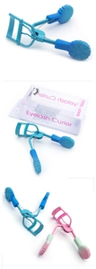 Detail of wide-angle eyelash curlers in blue and gradient pink with floral handles