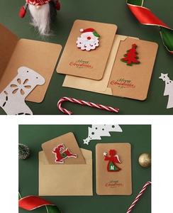 Flat lay of vintage kraft Christmas cards with felt Santas, reindeer and envelopes