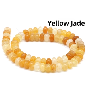 Macro shot of natural yellow jade abacus beads with polished finish for DIY jewelry making