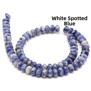 Macro view of white spotted blue natural stone abacus beads for DIY jewelry making