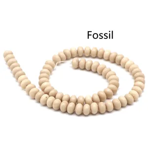 Close-up of ivory fossil abacus beads for DIY jewelry with natural mineral textures