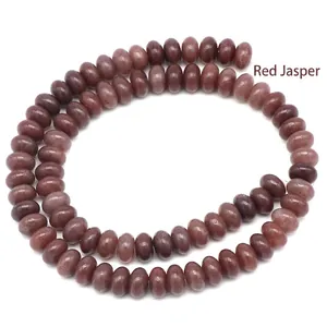 Macro detail of red jasper abacus beads showing natural stone texture and deep red finish