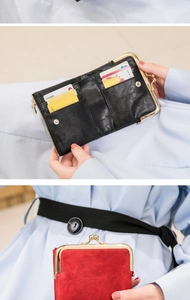 Macro view of vintage leather wallet showing card slots and retro metal clasp closure