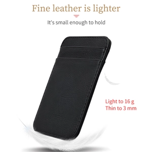 Slim black leather card holder weighing 16g and 3mm thin shown with feather