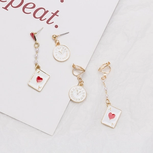 Detailed view of Alice in Wonderland earrings with poker card and clock motifs