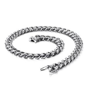 Polished silver stainless steel Cuban link necklace with dragon buckle on white background