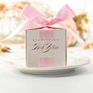 White square wedding favor box with pink ribbon bow and gold embossed lettering