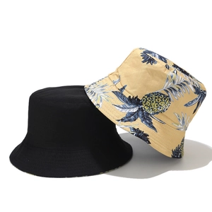 Reversible cotton bucket hat for women with black side and yellow pineapple print design