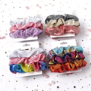 Close-up of sparkling sequin fabric scrunchies in colorful glitter sets for hair styling