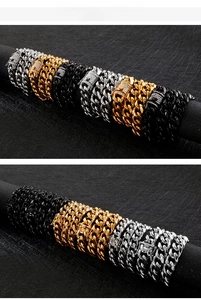 Detail view of gold, silver, and black hip-hop Cuban link chains with zircon clasps