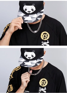 Detailed view of silver Cuban link chain necklace worn by model on studio background