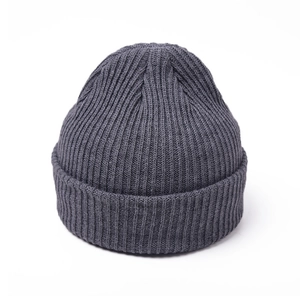 Detail of ribbed knit texture on a thick dark grey winter beanie hat for adults