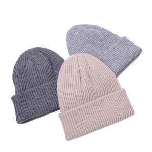 Three minimalist ribbed knit beanies in dark grey, light grey, and nude pink for winter warmth