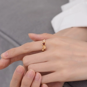 925 silver flower ring with red garnet gemstone and white crystals on finger