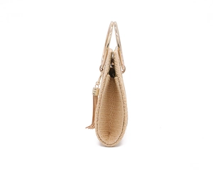 Detail of beige woven evening bag with round gold metal handle and side tassel accent