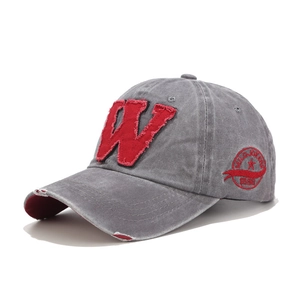 Detail of vintage gray baseball cap with red W embroidery and distressed patch detail