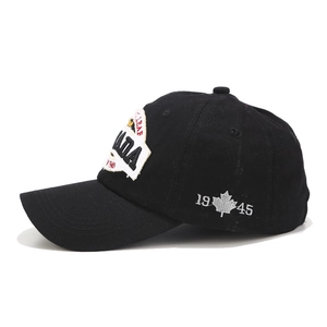 Black cotton baseball cap featuring CANADA embroidery and maple leaf side detail