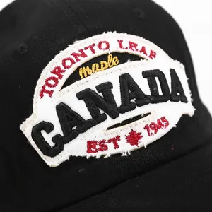 Black cotton baseball cap with Toronto Canada maple leaf embroidery and distressed patch