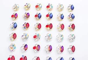 Macro view of colorful k9 glass crystal nail gems with gold and silver metal borders
