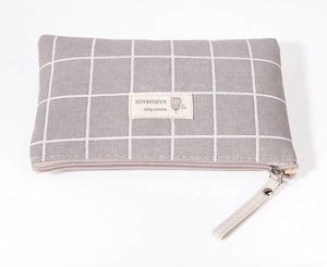 Detail of grey checkered large capacity makeup bag with zipper and handmade label
