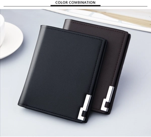 Detail of slim leather men wallets in black and dark brown with metallic logo accent