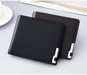 Detailed close-up of brown and black leather bifold wallets with silver metal accent