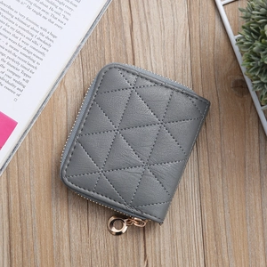 Detail of grey PU leather coin purse featuring geometric diamond stitching and gold zipper