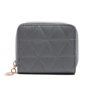 Detail of grey short wallet featuring geometric triangle quilting and rose gold zipper