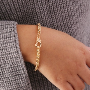 Close-up of a gold geometric chunky chain bracelet with unique clasp on a female wrist