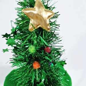 Detail of green velvet Christmas tree headband with colorful pom-poms and gold star