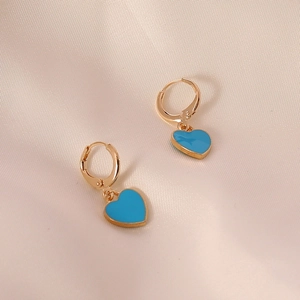 Elegant sky blue heart earrings with gold hoop design on soft silk fabric background