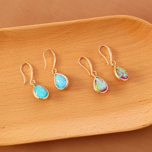 Elegant fan-shaped water drop hook earrings with blue and purple gemstones on gold base