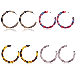 Set of four C-shaped acetate hoop earrings in tortoiseshell, leopard, and marble patterns
