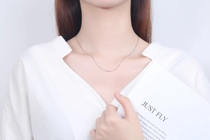 Minimalist 925 sterling silver snake chain necklace worn on a woman's collarbone