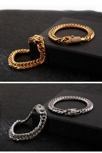 Detail of gold and silver cuban link bracelets with zircon-encrusted clasp on black box