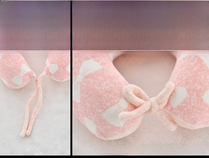 Pink memory foam U-shaped pillow for infants with bow print and adjustable safety strap