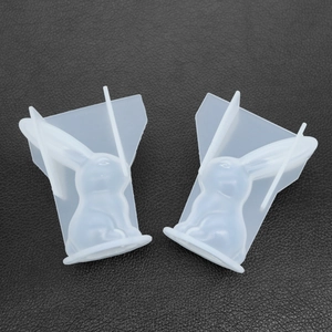 Macro view of translucent rabbit-shaped silicone resin molds on black texture