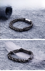 Detail of vintage double-layer stainless steel chain bracelet with a square clasp and antique finish