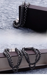 Detail of vintage industrial steel chain bracelets with geometric links and buckle clasp