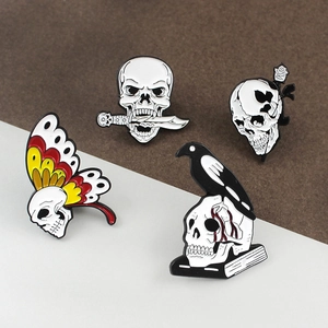 Lot de quatre broches gothiques en émail crâne avec rose, couteau et corbeau