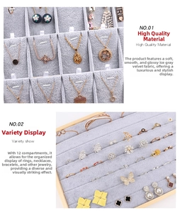 Detail of wooden jewelry tray set with 12-slot velvet inserts for rings and necklaces