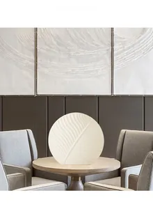 Detail of white ceramic flat leaf vase showing elegant veins in a Nordic interior setting