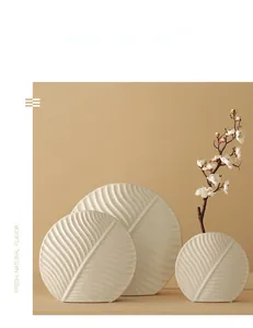 Detailed relief of leaf veins on a white ceramic decorative vase in Nordic style