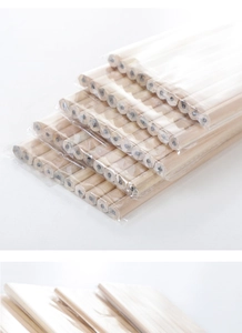 Close-up of bulk natural wood pencils in transparent packaging on white background