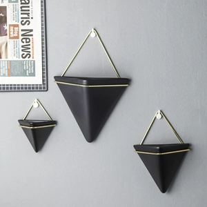 Set of three modern geometric wall planters in matte black and gold metal frames