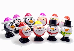Variety of wind-up Christmas toys including Santa, penguin and snowman characters